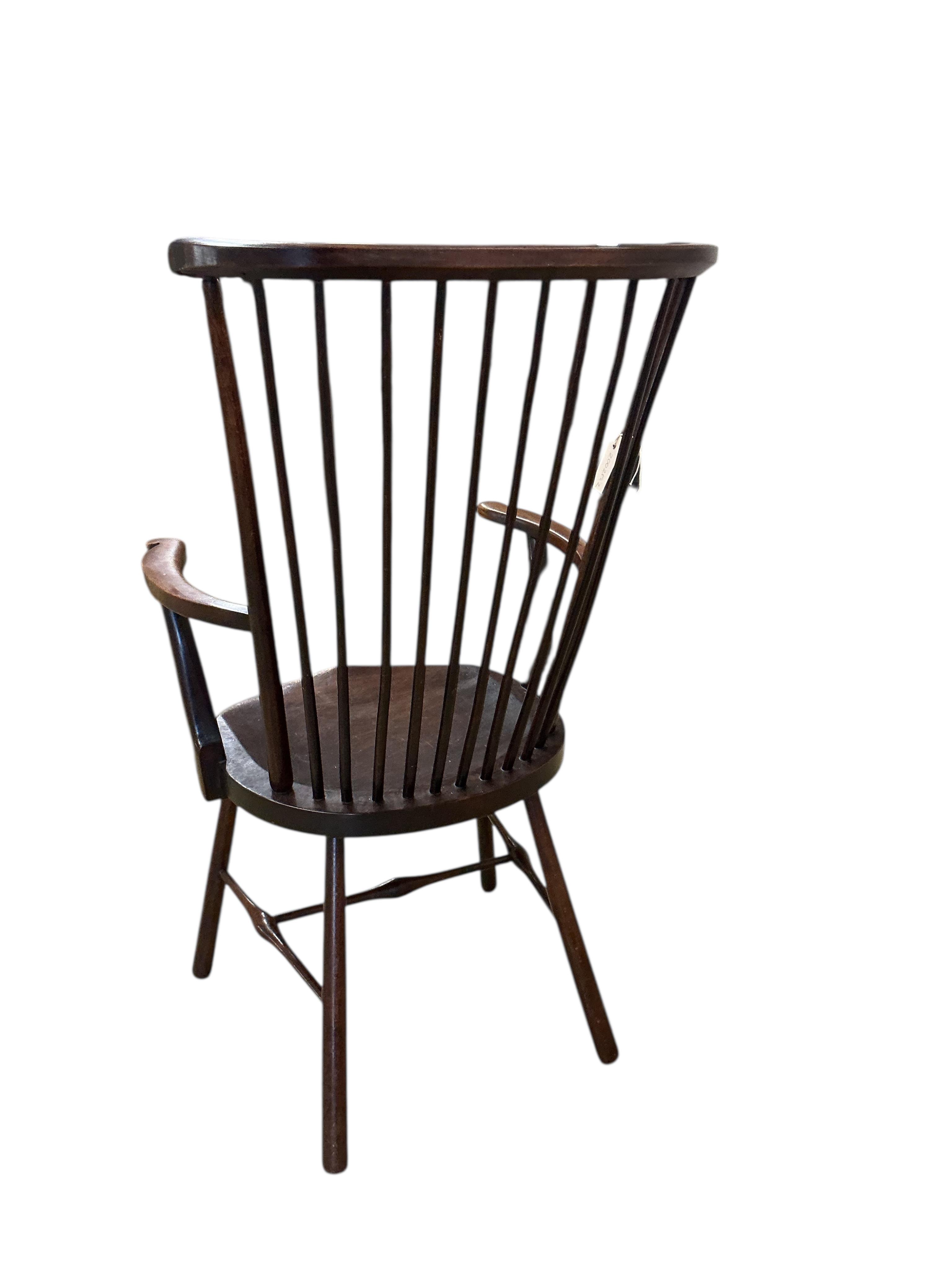 An Arts & Crafts Liberty style Windsor comb back armchair, width 59cm, depth 43cm, height 109cm